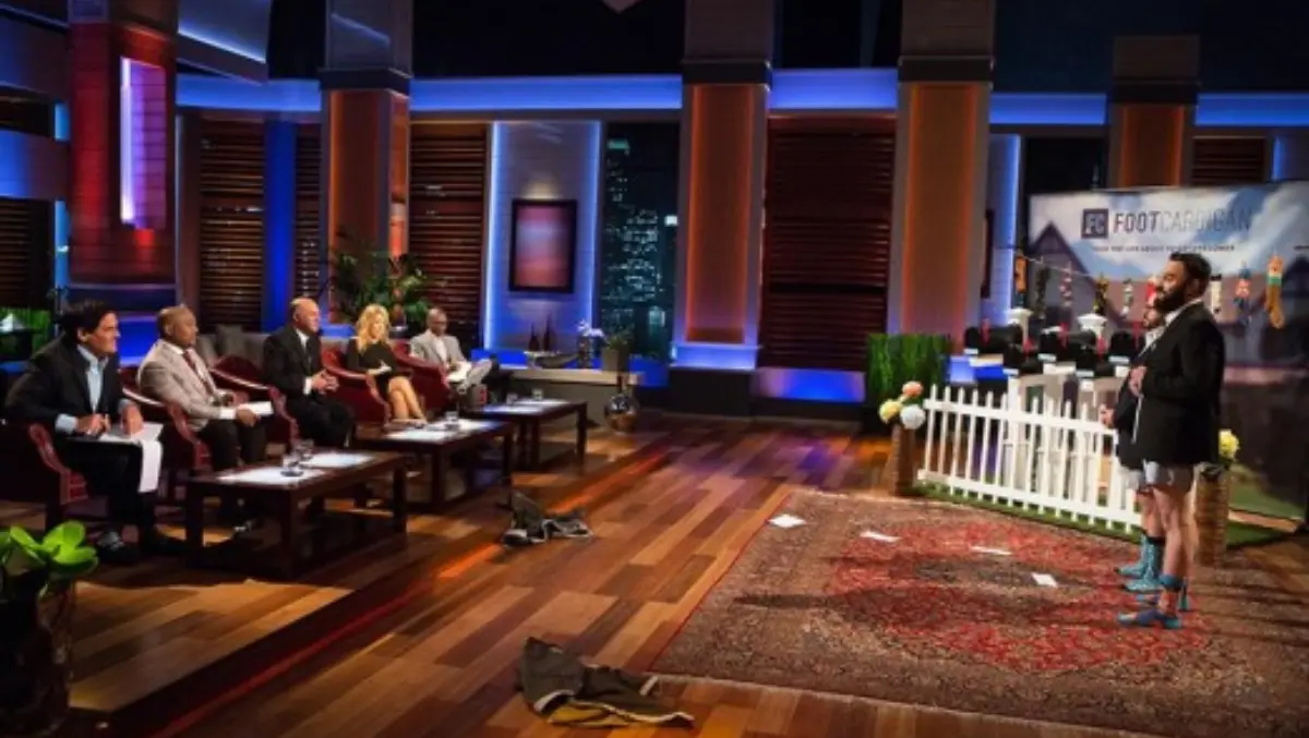 Bryan DeLuca pitching Foot Cardigan to the investors on Shark Tank, wearing a blazer and no pants